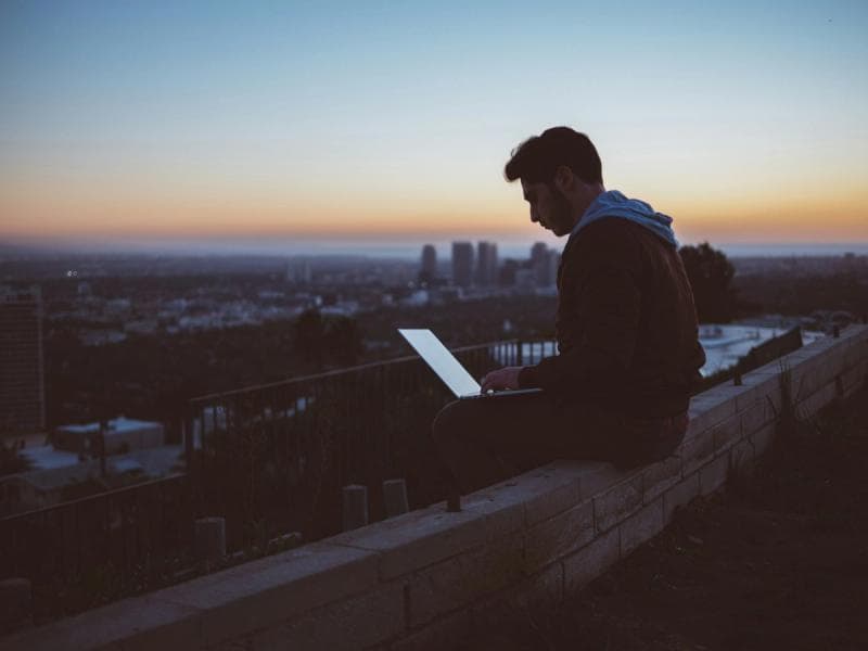 man sitting on roof top - Best Email Apps