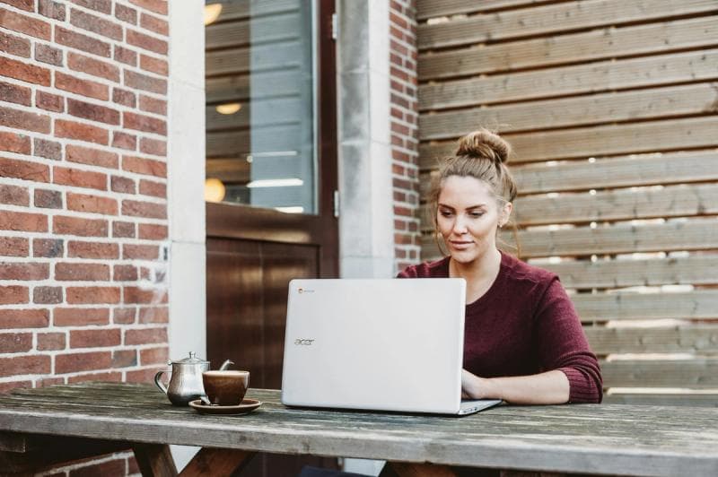 woman sitting outdoor and using tools - AI Email Management